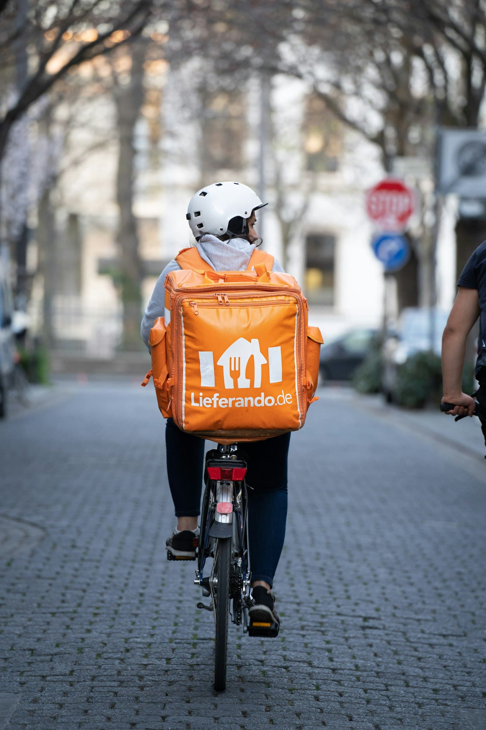 A delivery rider securing a food box